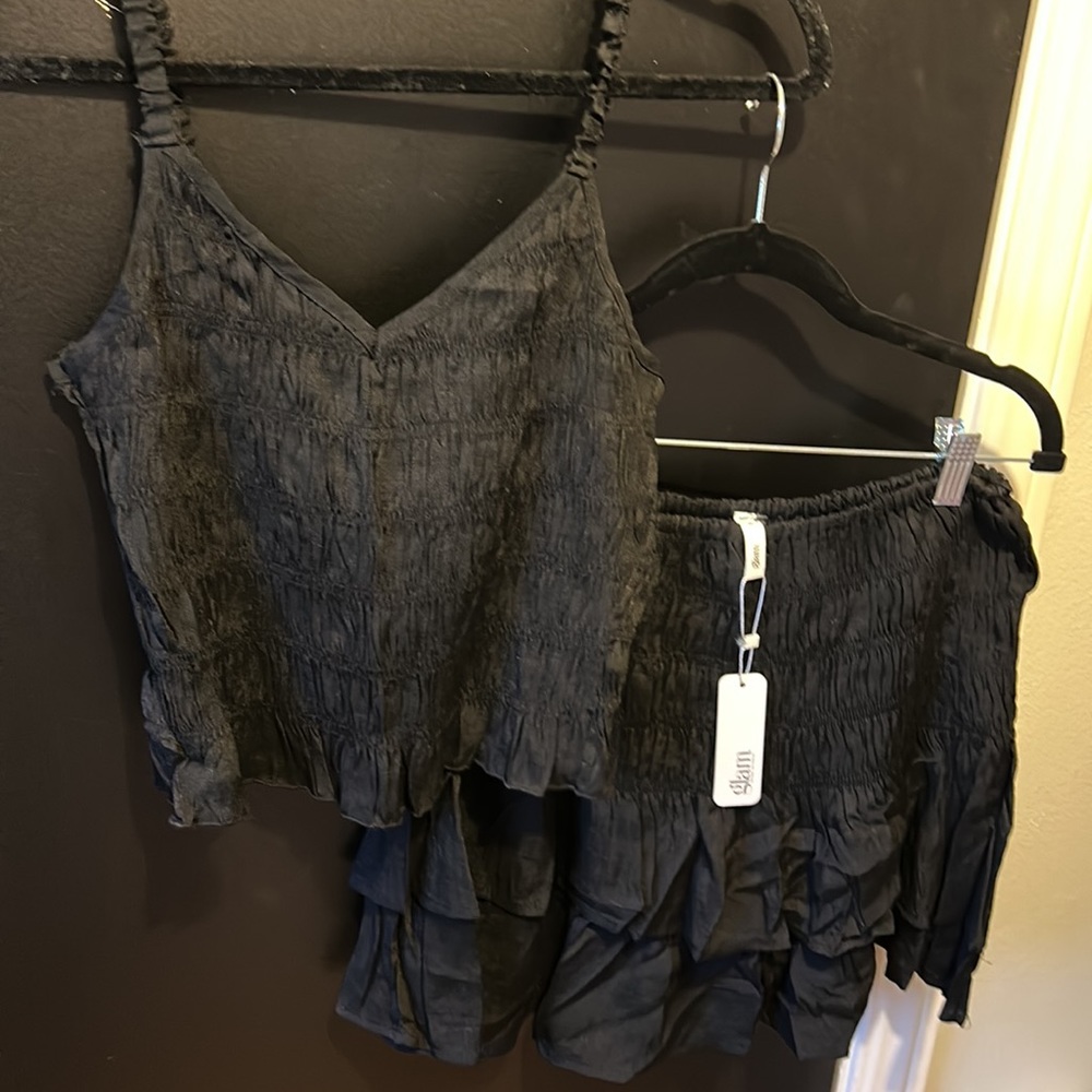 Glam women’s black tank and ruffle skirt set
